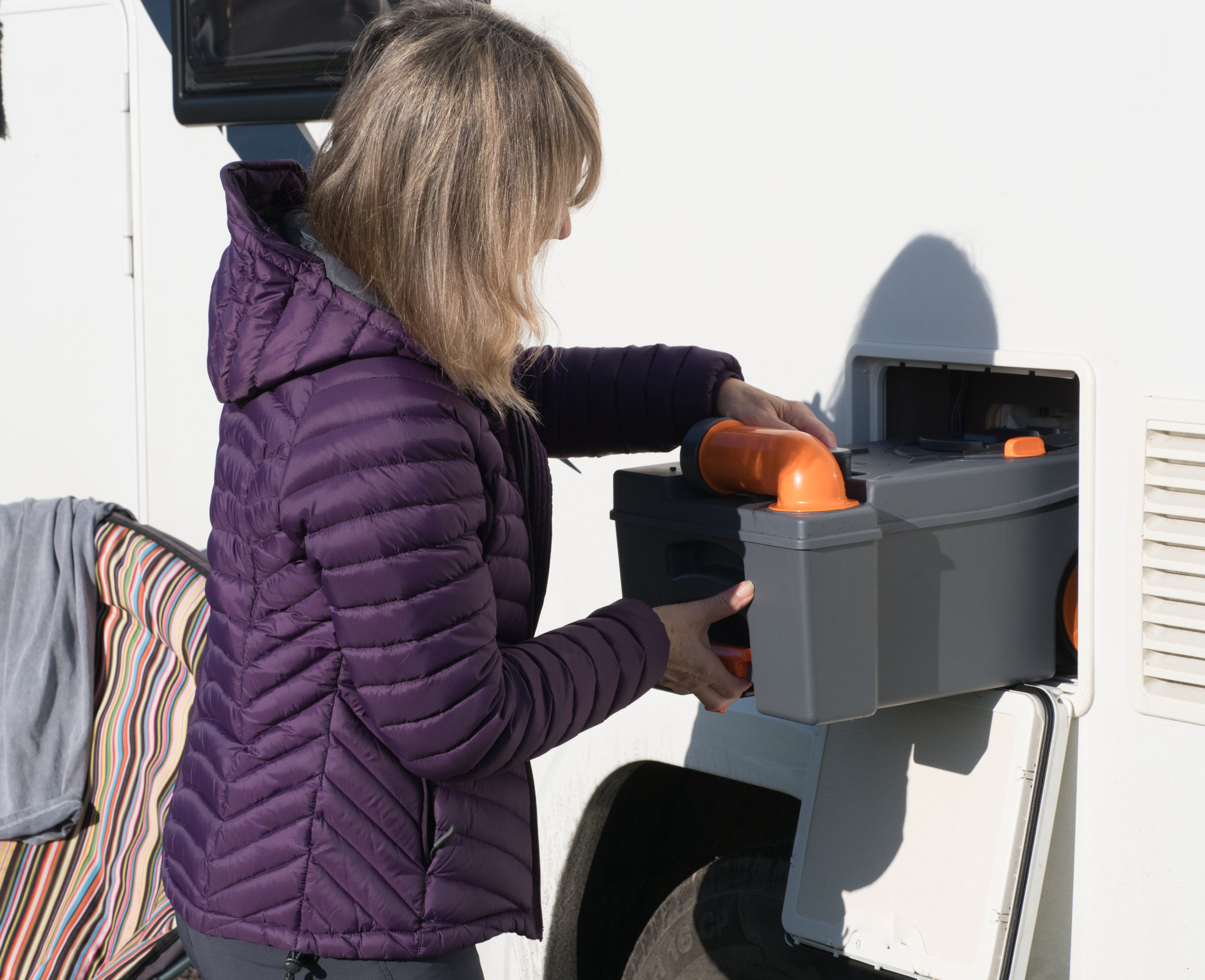 RV owner performing maintenance on RV